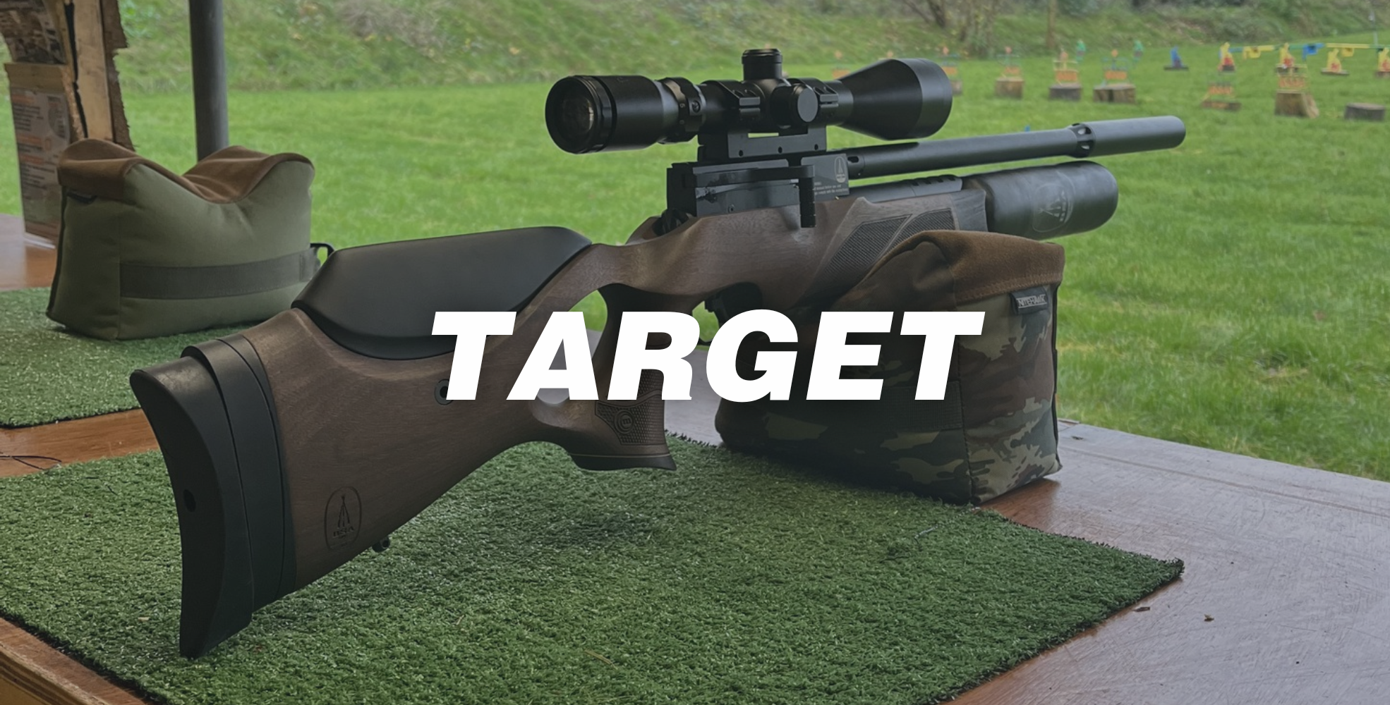 A scoped rifle rests on a shooting bench outdoors, supported by sandbags, ideal for a junior or beginner shooter, with grassy target lanes in the background. The word "TARGET" is overlaid in bold white text across the image.