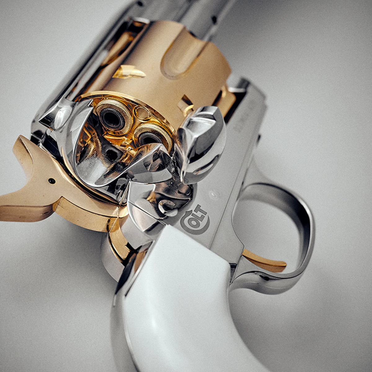 Colt SAA 'Smoke Wagon' CO2 Pistol 3 Close-up of the Colt SAA CO2 Smoke Wagon Pistol .177 Pellet, featuring a silver and gold finish with a white handle, open cylinder, and detailed metalwork—ideal for realistic pellet shooting.