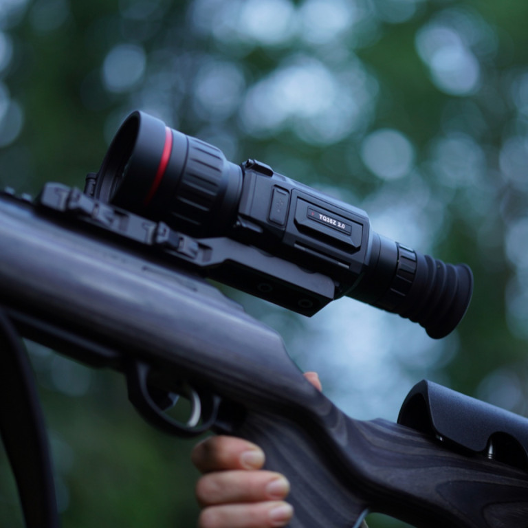 HIKMICRO Thunder Pro Zoom 2.0 TQ60Z Optical Thermal Rifle Scope 3 A blurred image with out-of-focus blue and green circular light spots, reminiscent of the abstract bokeh effect seen through a HIKMICRO Thunder Pro Zoom 2.0 TQ60Z Optical Thermal Rifle Scope.